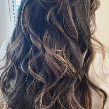 half updo with loose falling curls to create a stunning look from behind